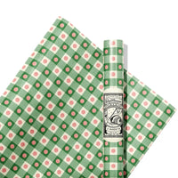 Green and pink polka dot and checkered patterned paper with a brand label on a white background