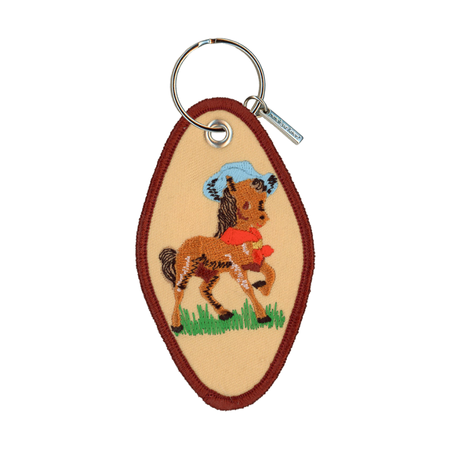 Tan embroidered motel-style keychain featuring a horse wearing a cowboy hat