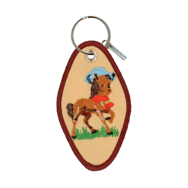 Tan embroidered motel-style keychain featuring a horse wearing a cowboy hat