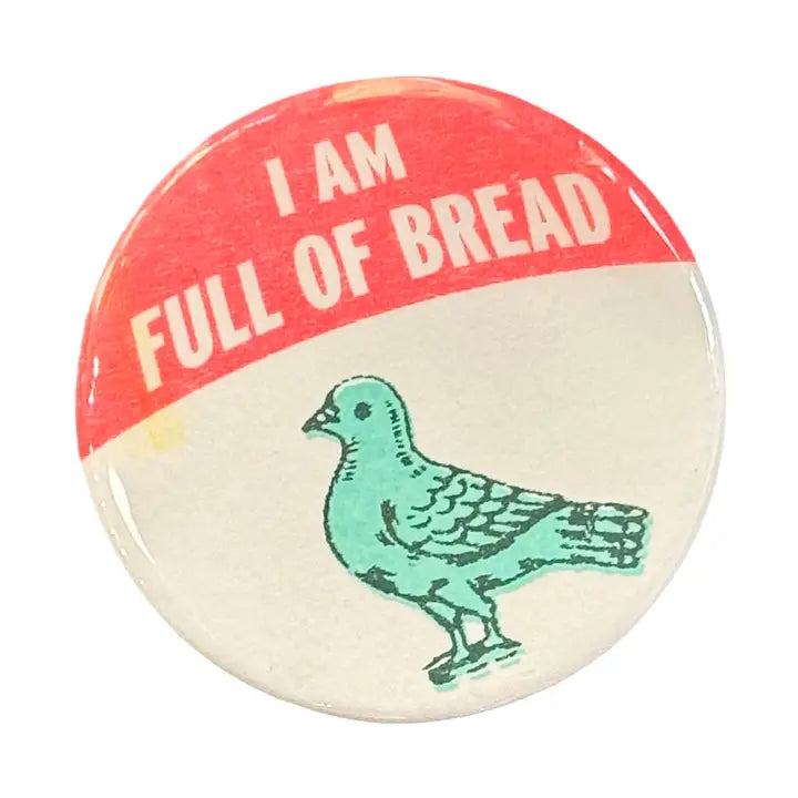 Circular button featuring a blue illustrated pigeon on an off-white background with the text "I AM FULL OF BREAD"