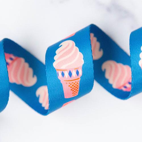 Blue webbing with pink ice cream cone pattern on a white background