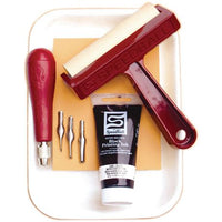 Block printing tools including a roller, ink bottle, and cutters on a white background