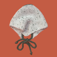 Knitted bandana with green strings on an orange background