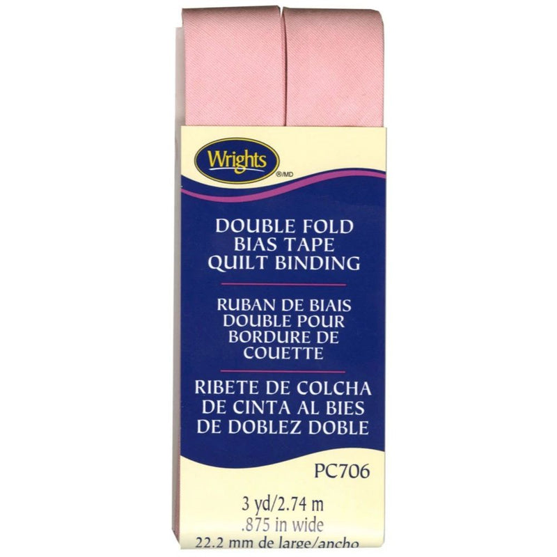 Box of Wright's double fold bias tape quilt binding with pink fabric strip on a white background