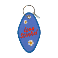 Blue embroidered motel-style keychain that reads "love stinks!"