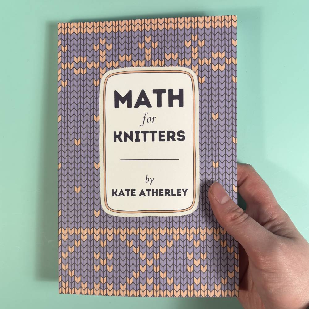 Book titled 'Math for Knitters' by Kate Atherley held by a hand on a light green background