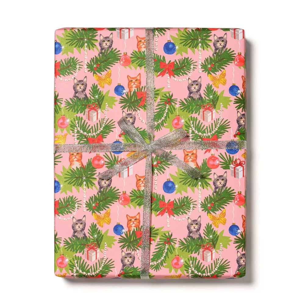 Gift wrap with cats, ornaments and greenery on a pink background