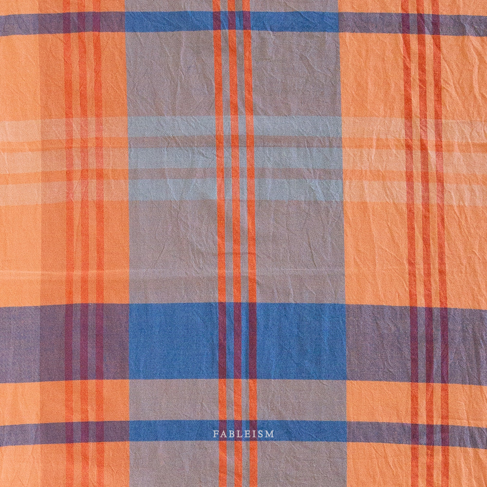 Plaid fabric with orange, blue, and gray colors 