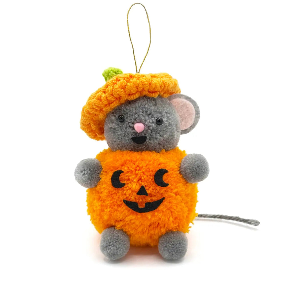 A plush mouse dressed in a fuzzy orange pumpkin costume with a small green stem and a gold hanging loop, photographed on a clean white background.