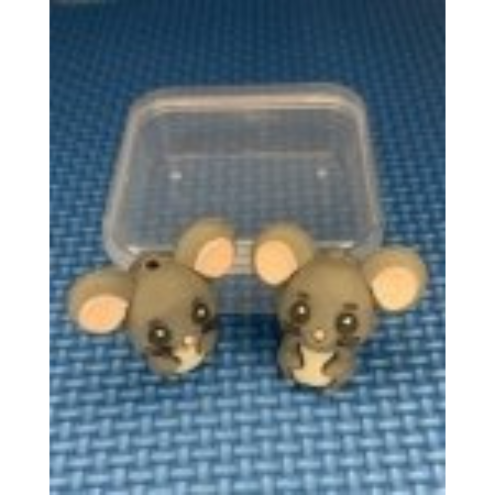 Two mouse-shaped point protector in a clear plastic case on a blue textured background