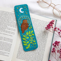 Embroidered bookmark with owl design on an open book with flowers