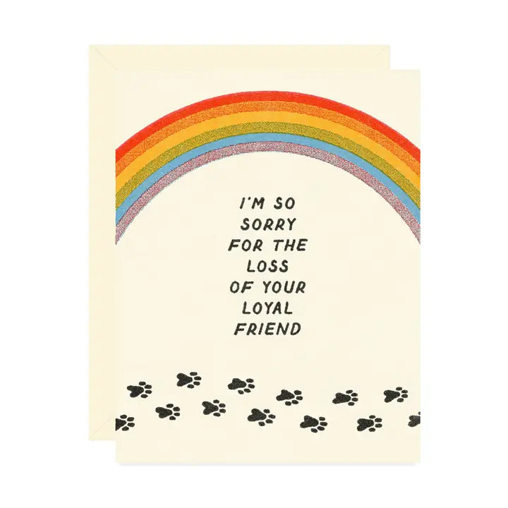 Beige greeting card featuring a rainbow and trailing paw prints with the message “I’m so sorry for the loss of your loyal friend" on a white background.