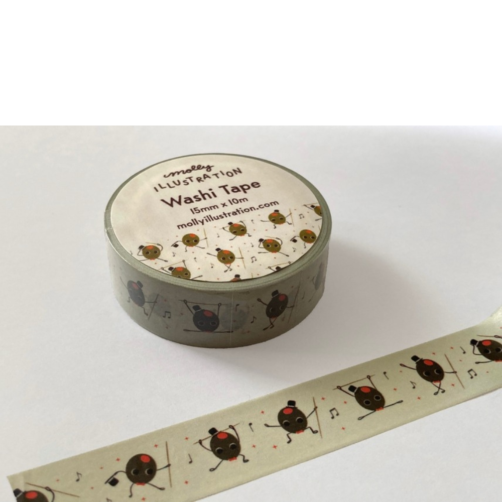 A roll of washi tape with a pattern of dancing olives and musical notes on a light background, shown with the label visible and a strip unrolled in front on a white surface.