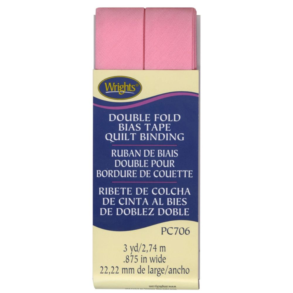 Packaged Wrights double fold bias tape quilt binding with pink tape on a white background