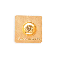 Gold magnetic back on a gold square with "Sarah Hearts" embossed at the bottom. 