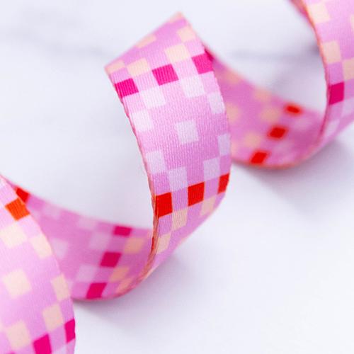 Close-up of pink checkered webbing on a white background