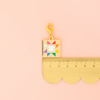 Colorful charm with a star design on a pink background