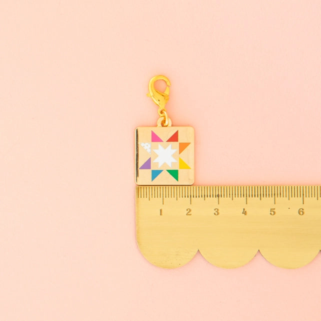 Colorful charm with a star design on a pink background