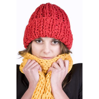 Person wearing a red knitted hat and yellow scarf on a white background