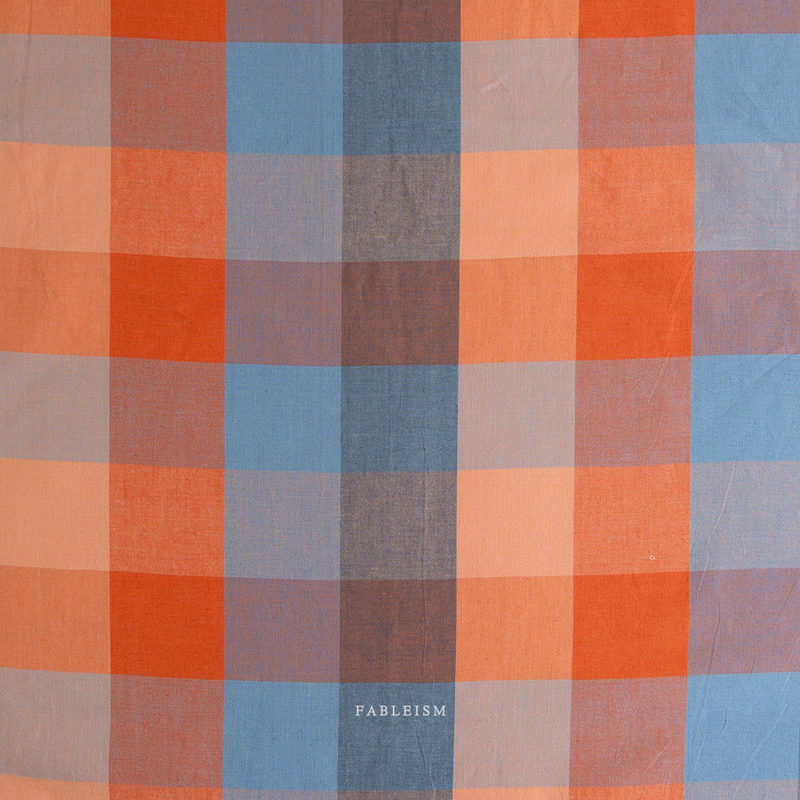 Plaid fabric pattern with orange, blue, and brown colors