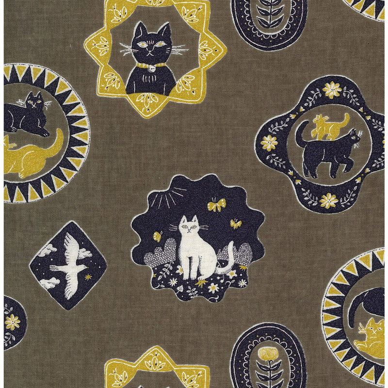 Patterned fabric with designs featuring cats, birds, and flowers on a brown background