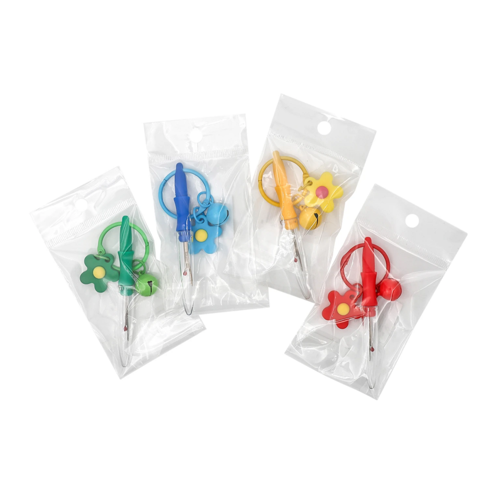 Set of colorful sewing accessories in clear packaging on a white background