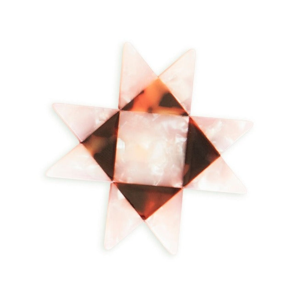 Geometric star-shaped object with a light pink and brown color pattern on a white background