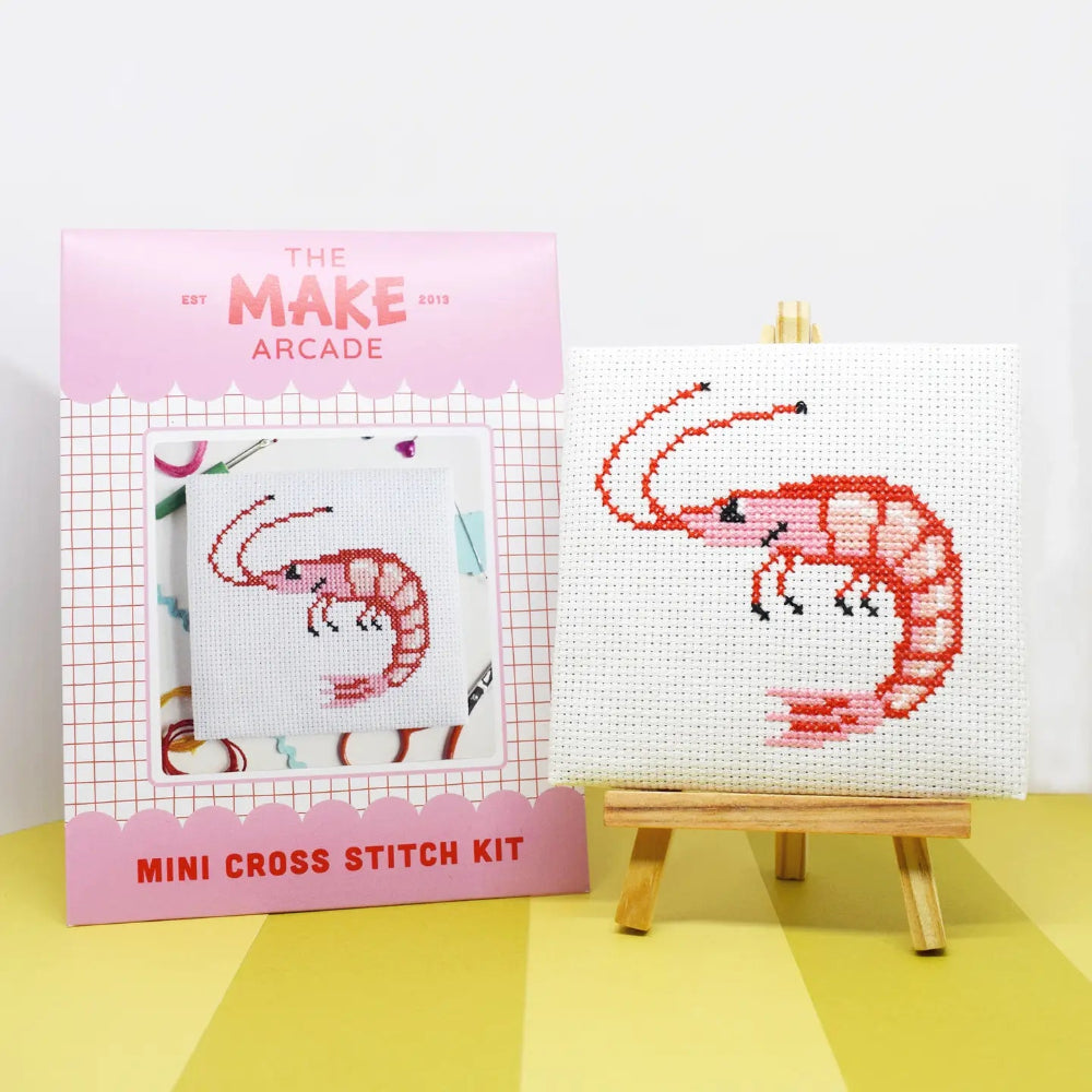 Mini cross stitch kit with a shrimp design on a white fabric background, featuring 'The Make Arcade' branding.