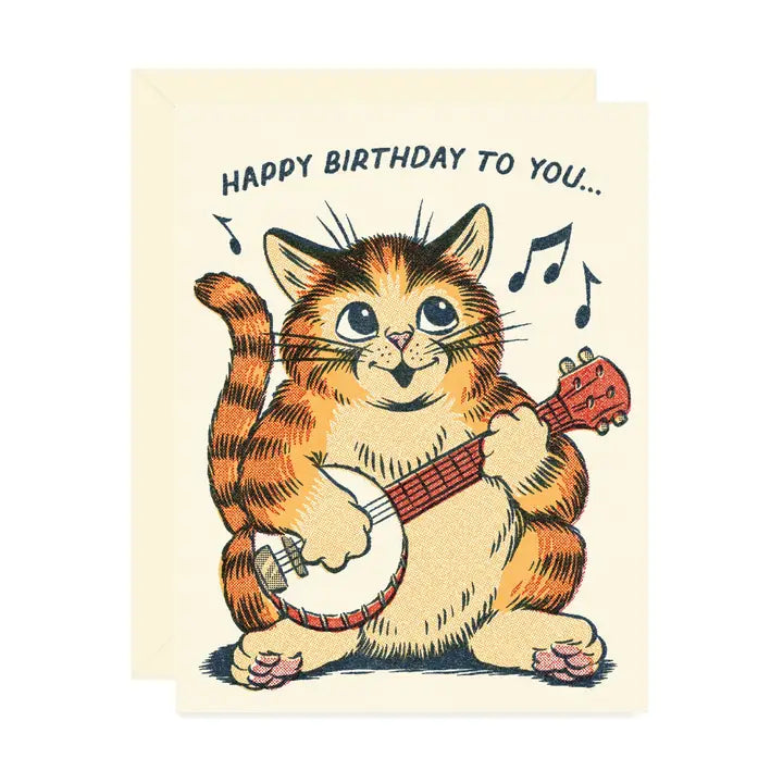 Beige birthday card featuring a singing cat strumming a banjo and wishing “happy birthday to you" on a white background.
