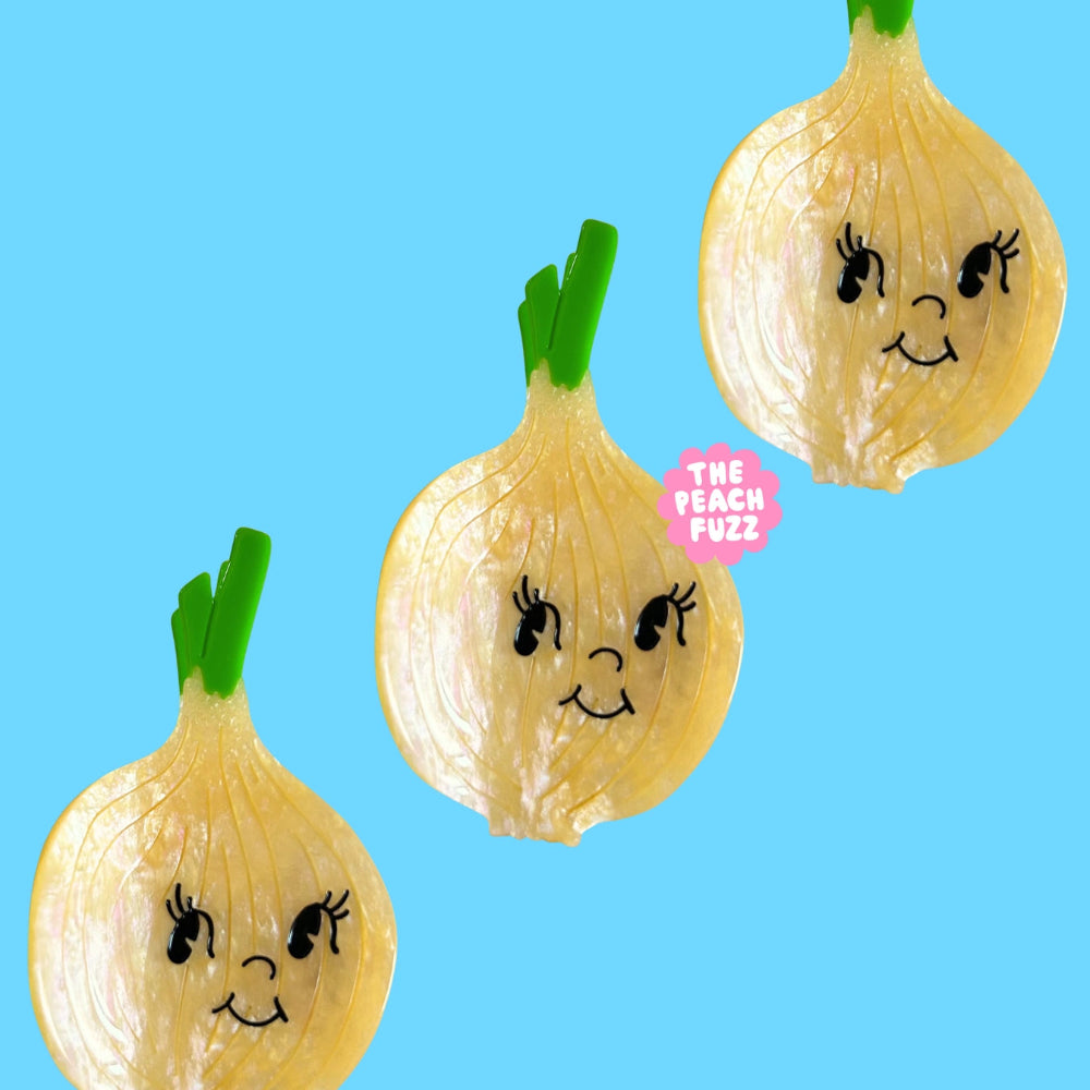 Three cartoon-style onions with faces on a blue background, featuring the brand 'The Peach Fuzz'.