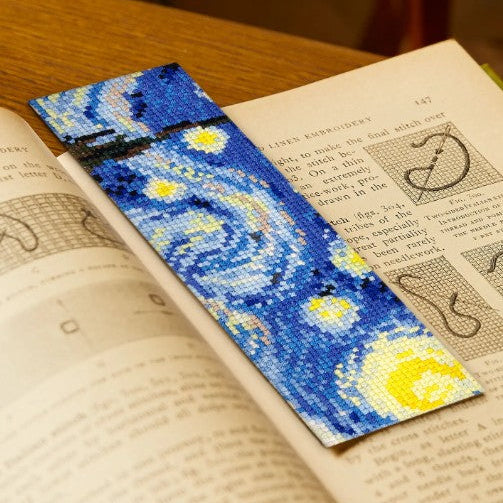 Starry Night bookmark on an open book with a blurred background