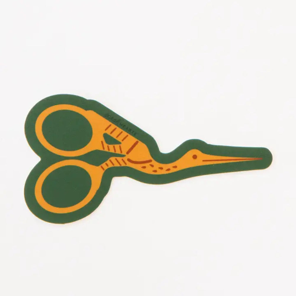 A sticker with an illustration of yellow stork scissors with a green background. 
