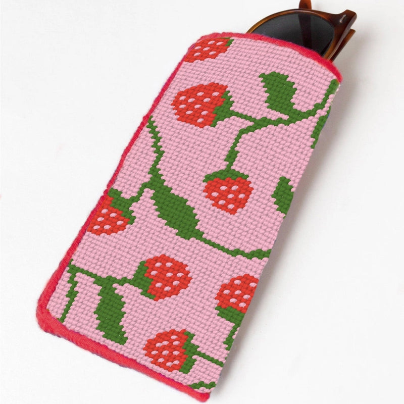 Needlepoint sunglasses case with a pink and red strawberry design on a white background