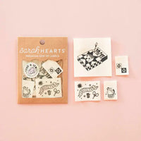 Labels with designs including "Quilter," a matchstick box and a chicken in Sarah Hearts packaging