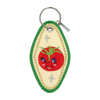 Embroidered motel-style keychain featuring a tomato and gold border