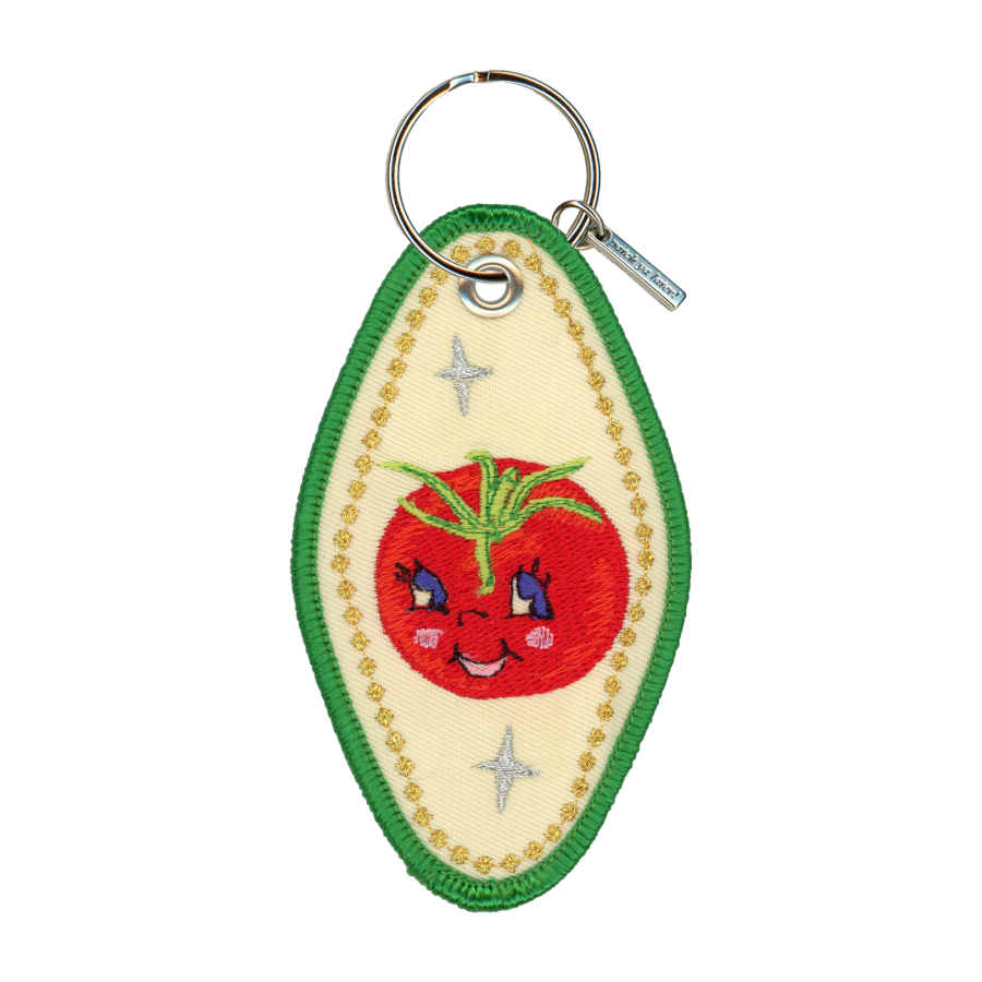 Embroidered motel-style keychain featuring a tomato and gold border