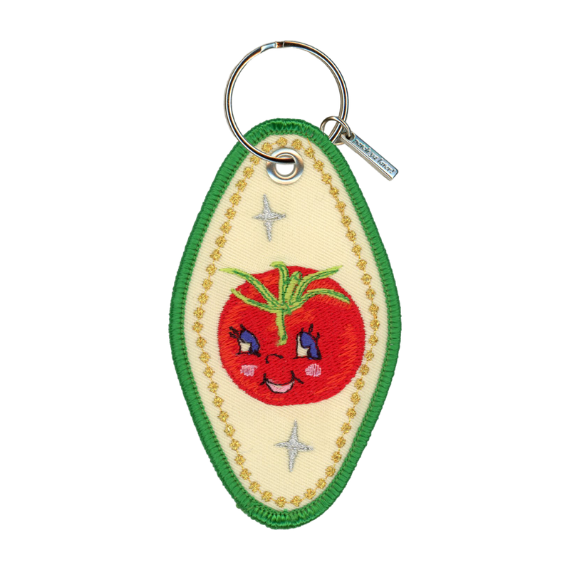 Embroidered motel-style keychain featuring a tomato and gold border