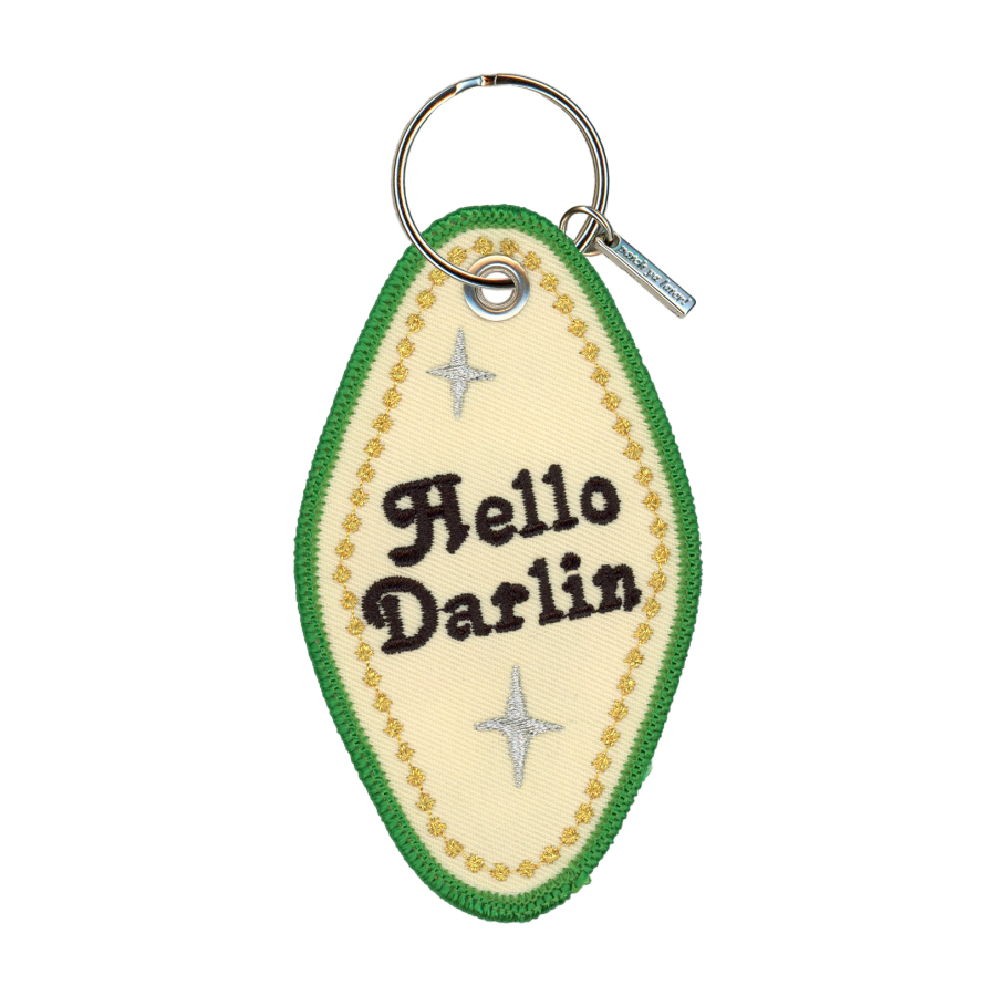 Embroidered motel-style keychain that reads "hello darlin" with a gold border