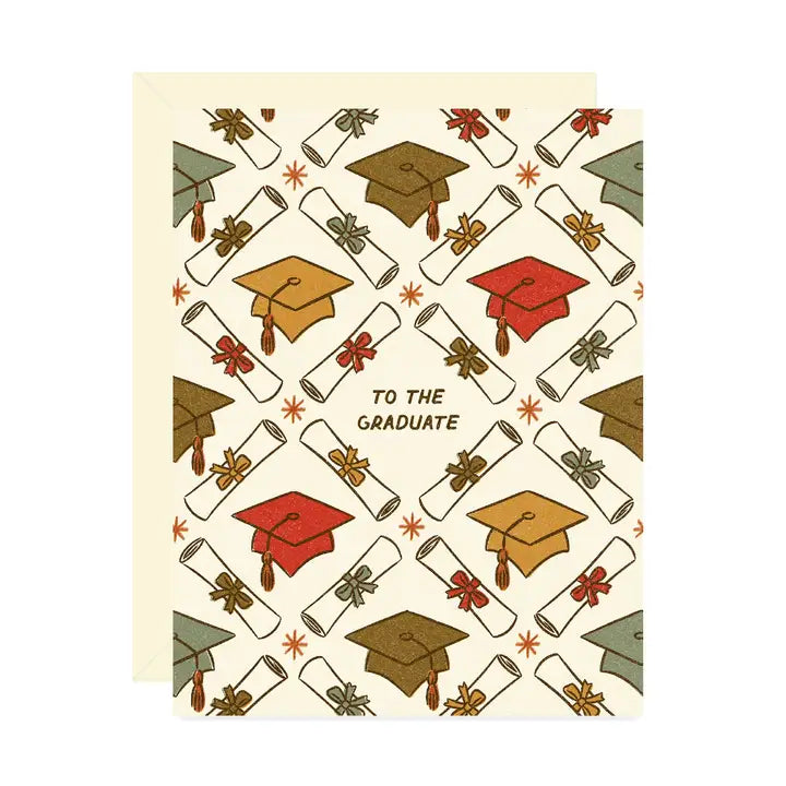 Beige card featuring an interlocking pattern of hats and diplomas framing the text: “to the graduate" on a white background.