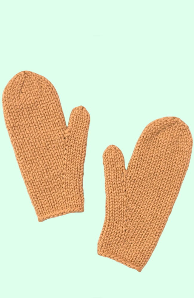 Knit light brown mittens on an aqua blue background.